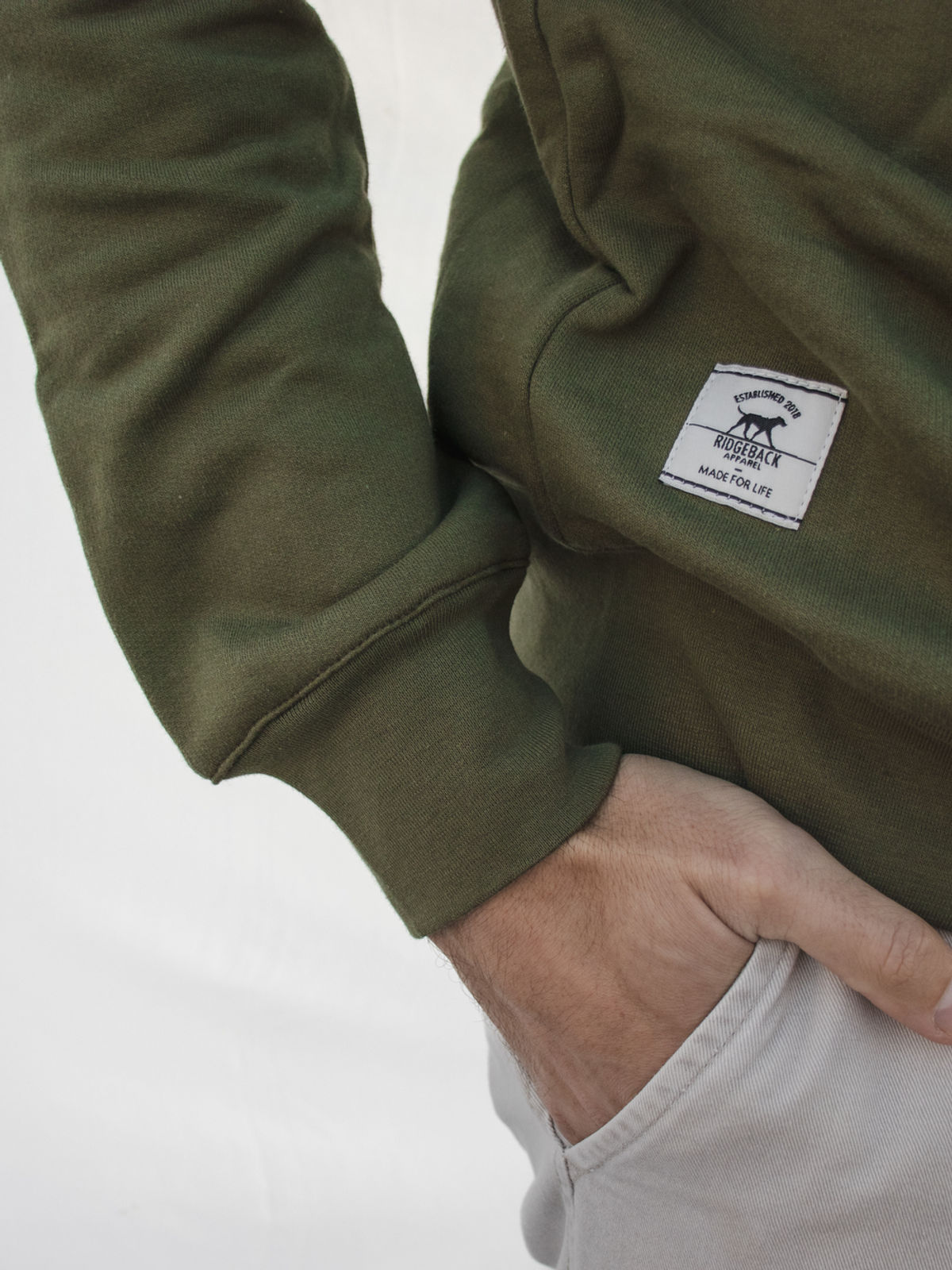 Olive sweater with the woven Ridgeback label